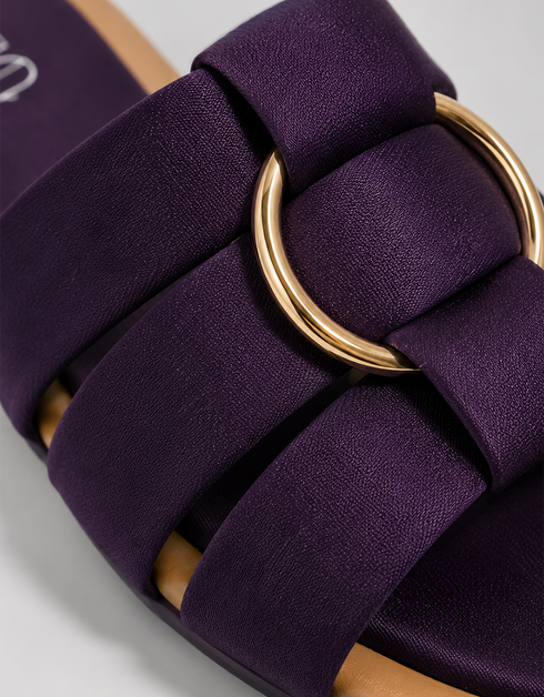 Close up of purple multi strap flat sandals highlighting the metallic ring detail and premium finish.