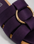 Close up of purple multi strap flat sandals highlighting the metallic ring detail and premium finish.