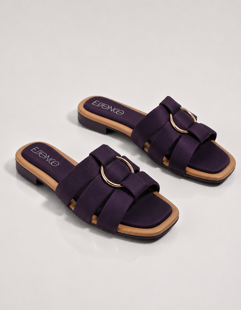 Pair of purple multi strap flat sandals featuring a statement metallic ring and soft cushioned footbed.