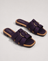 Pair of purple multi strap flat sandals featuring a statement metallic ring and soft cushioned footbed.