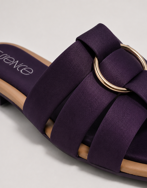 Close up of purple multi strap flat sandals highlighting the metallic ring detail and premium finish.
