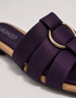 Close up of purple multi strap flat sandals highlighting the metallic ring detail and premium finish.
