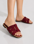 Woman wearing red multi strap flat sandals styled with casual and festive outfits.