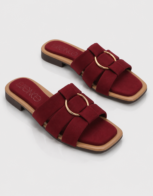 Pair of red multi strap flat sandals with statement metallic ring and soft cushioned sole.
