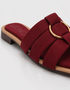 Close up of red multi strap sandals highlighting the statement metallic ring and premium craftsmanship.