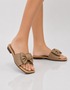 Model wearing Meherin beige bow flat sandals with oversized bow detail, gold buckle accent, and soft cushioned comfort.