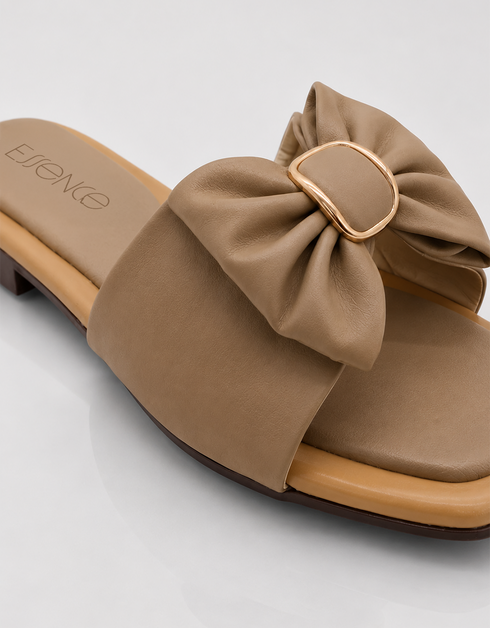 Detail Close up beige bow flat sandal with oversized bow detail and soft cushioned sole.