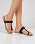 Woman wearing black braided flat sandals minimalist everyday styling