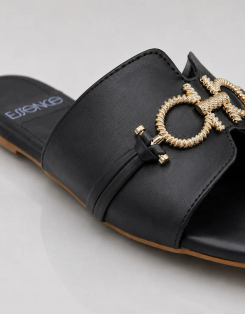 Close up of the gold metal buckle on Nova Chic Comfort Flat Sandals in Black with premium craftsmanship.