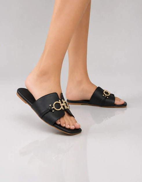 Model wearing Nova Chic Comfort Flat Sandals in Black styled for everyday casual wear.