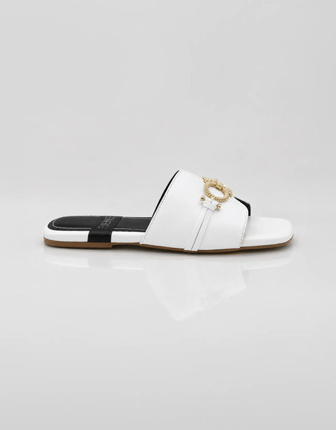 Side profile of Nova Chic Comfort Flat Sandals in White highlighting the slip on silhouette and gold buckle.