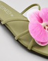 Close-up of pink orchid flower embellishment on olive green flat sandal padded sole