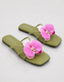 Pair of olive green flat sandals with pink orchid flower detail summer footwear