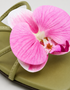 Close-up of pink orchid flower embellishment on olive green flat sandal padded sole