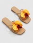 Pair of flat sandals with yellow flower detail stylish summer footwear for women