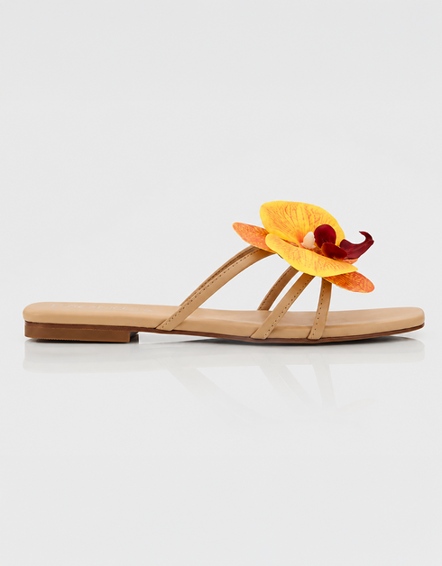Side view of yellow floral flat sandal with orchid detail and minimal straps