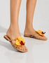 Woman wearing yellow flower flat sandals with summer outfit casual styling