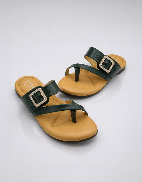 Pair of green buckle flat sandals featuring a modern dual strap design and soft cushioned sole.