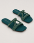 Pair of teal embellished flat sandals with shimmering straps and cushioned comfort.
