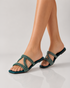 Woman wearing teal embellished flat sandals styled with casual and festive outfits.