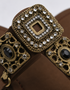 Close-up of antique gold buckle and embellishment on Kolhapuri flat sandal