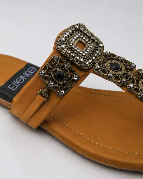 Close-up of antique gold buckle and embellishment on Mustard Kolhapuri flat sandal