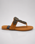 Side view of Kolhapuri flat sandal with gold embellishment and toe ring design