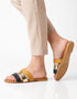 Woman wearing mustard flat sandals styled for everyday casual outfits.