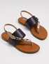 Pair of brown flat sandals with textured strap detailing