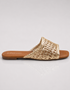 Gold woven sandal on a light gray background