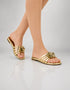 Model wearing Imperial gold flower embellished flat sandals for festive occasion