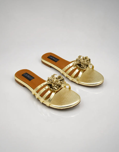 Pair of Imperial gold handmade flat sandals with strappy design and flower accent