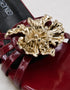 Close up of metallic flower embellishment on Imperial maroon patent flat sandals