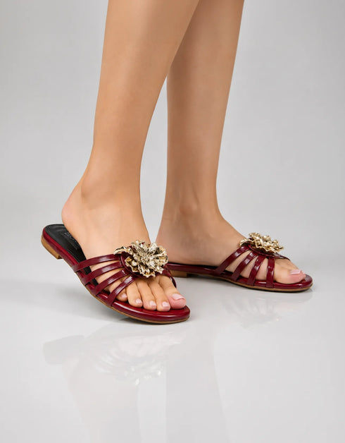 Model wearing Imperial maroon flower embellished flat sandals for formal occasion