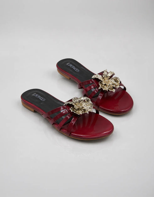 Pair of Imperial maroon handmade flat sandals with strappy patent design and flower accent