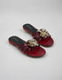 Pair of Imperial maroon handmade flat sandals with strappy patent design and flower accent