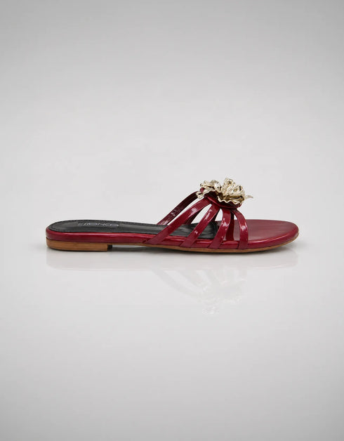 Side view of Imperial maroon patent flat sandals showing comfort sole and metallic flower detail