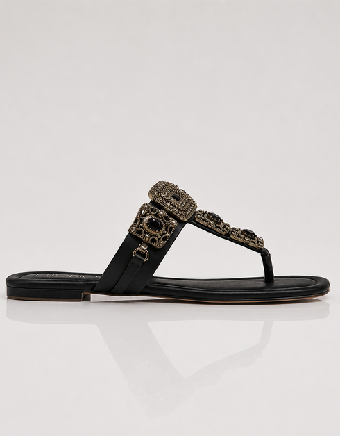 Black sandal with decorative strap on a white background