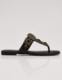 Black sandal with decorative strap on a white background